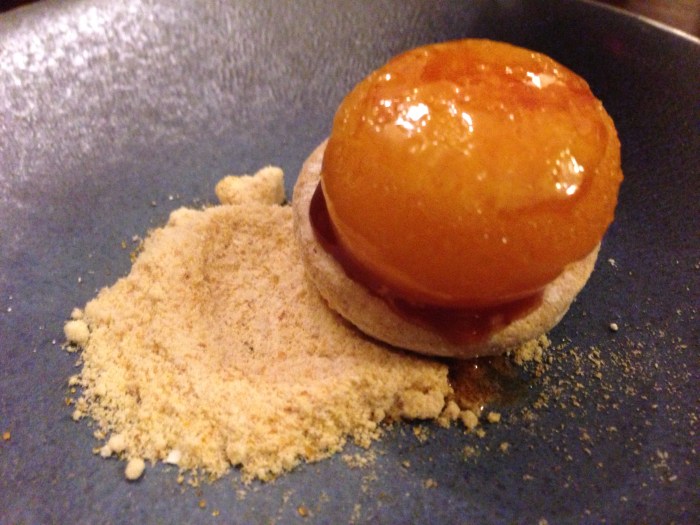 this was a bizarre dessert - it was like a shortbread cookie a layer of something and then a bruleed egg yolk ... when the egg yolk explodes in your mouth and then the salt and the sugar broke through